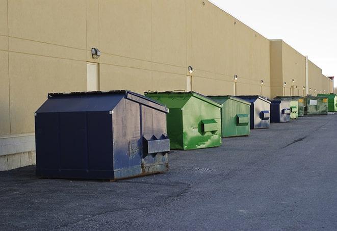 construction workers toss wood scraps into a dumpster in Brownsville